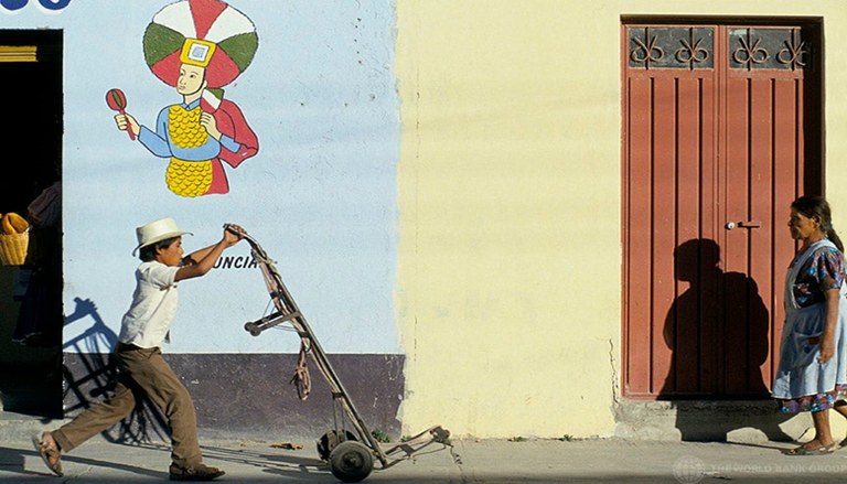 A man walking with a dolly on the streets of Oaxaca, Mexico