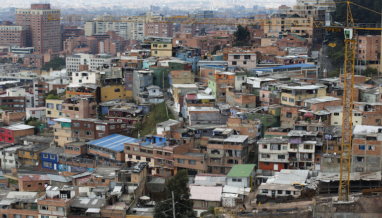 Overhead view of a dense city in developing world with several construction frames